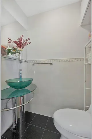 a bathroom with a sink mirror and toilet