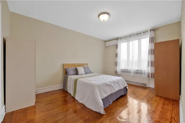 a bedroom with a bed and large window