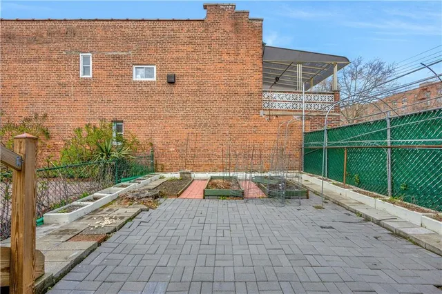 a view of a chairs and tables in the back yard of the house