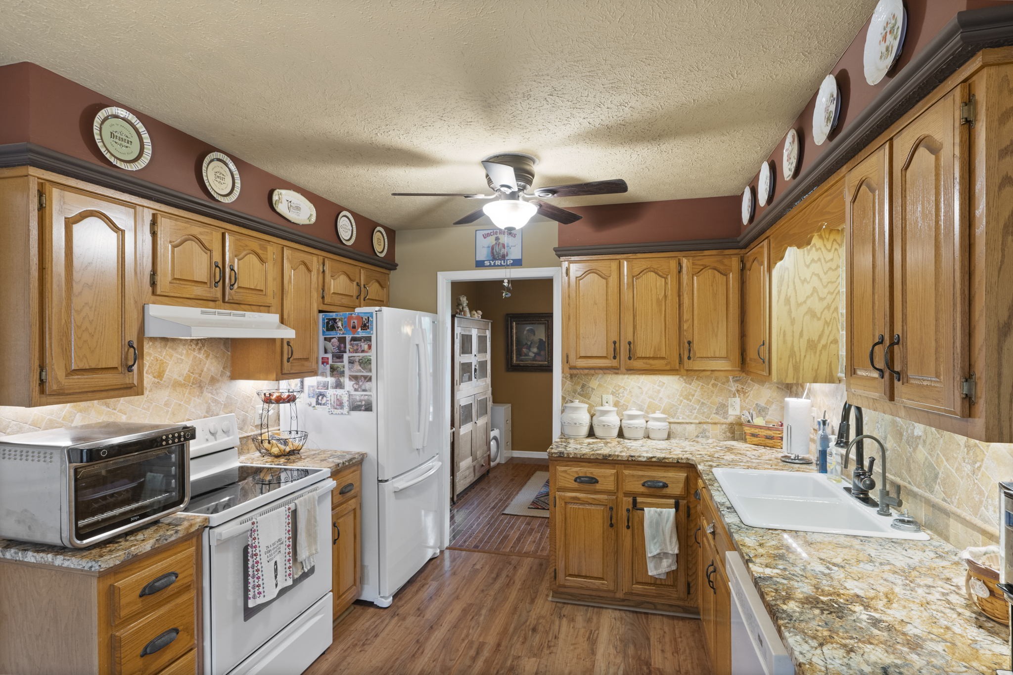 7313 West Cook Road Springfield, TN 37172 - Photo 11 of 40 a large kitchen with stainless steel appliances granite countertop a lot of counter space and a wooden floor