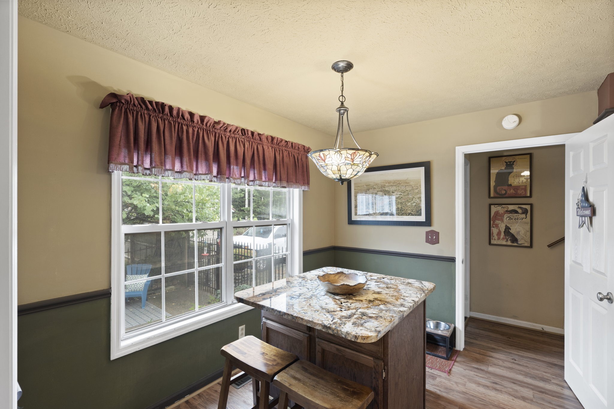 7313 West Cook Road Springfield, TN 37172 - Photo 13 of 40 a view of a dining room with furniture wooden floor and chandelier