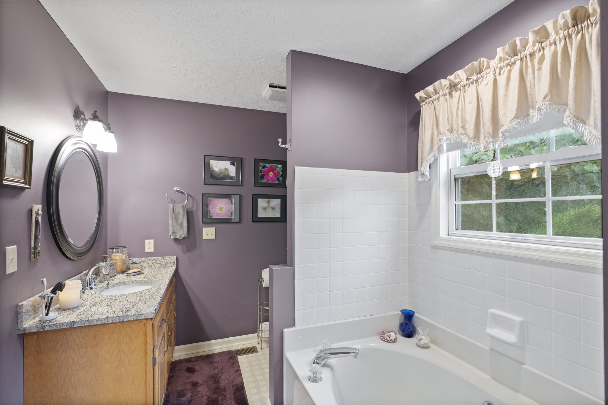 7313 West Cook Road Springfield, TN 37172 - Photo 23 of 40 a bathroom with a granite countertop sink mirror vanity and a bathtub