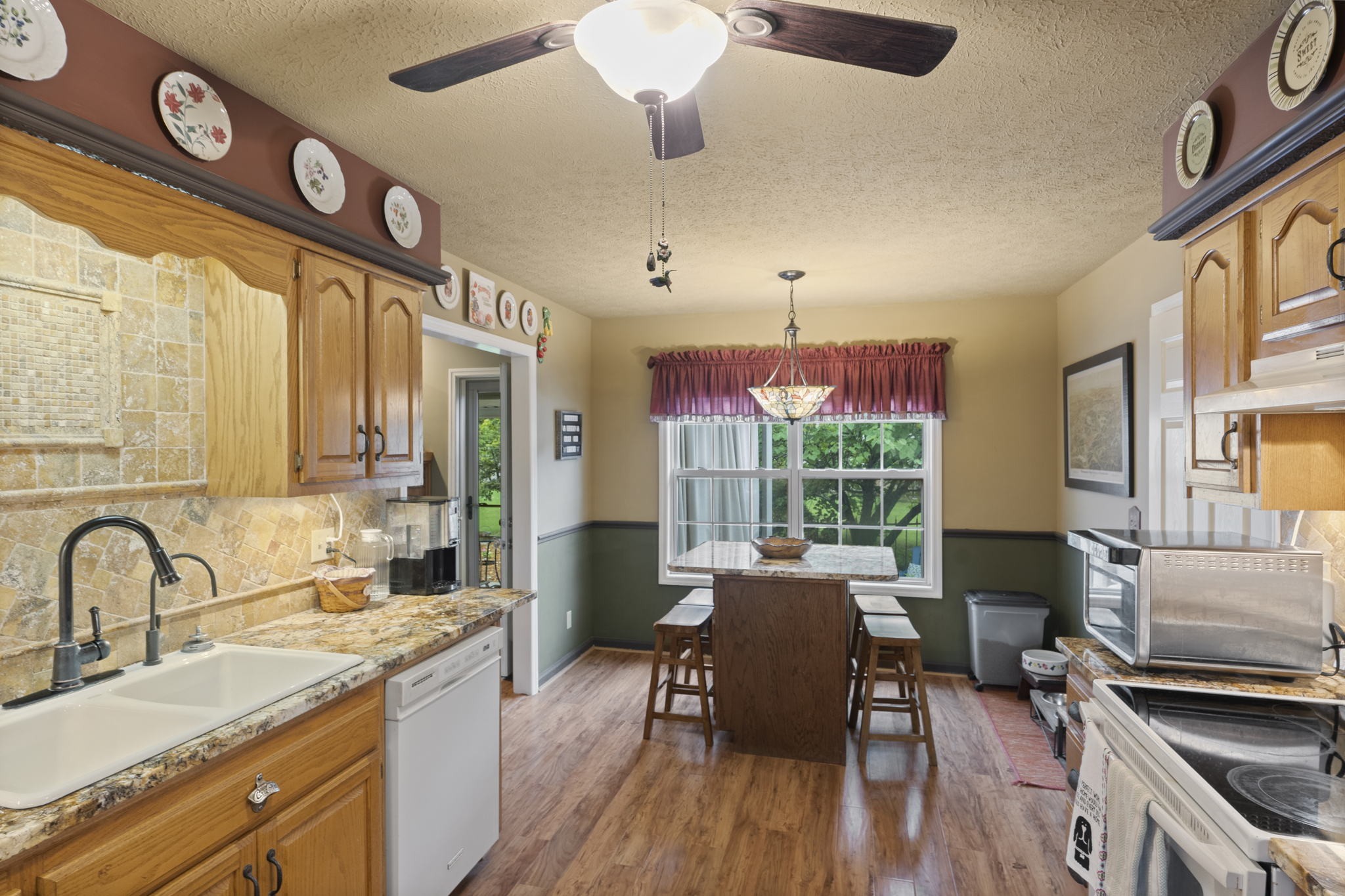 7313 West Cook Road Springfield, TN 37172 - Photo 9 of 40 a large kitchen with a large window and stainless steel appliances