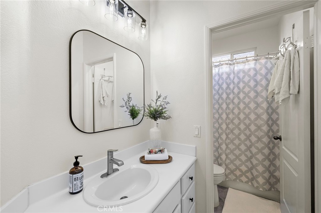 9 Paverstone Lane Ladera Ranch, CA 92694 - Photo 21 of 51 a bathroom with a sink a toilet and shower curtain