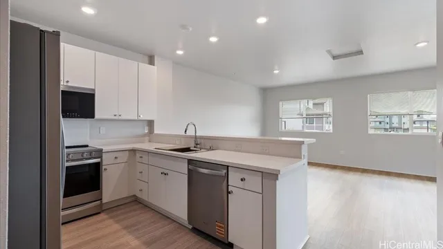 a kitchen with a sink stove and cabinets