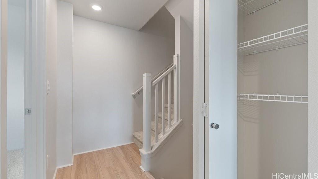 91-4099 Hikuono Street, Unit 1402 Kapolei, HI 96707 - Photo 6 of 25 a view of a hallway with staircase
