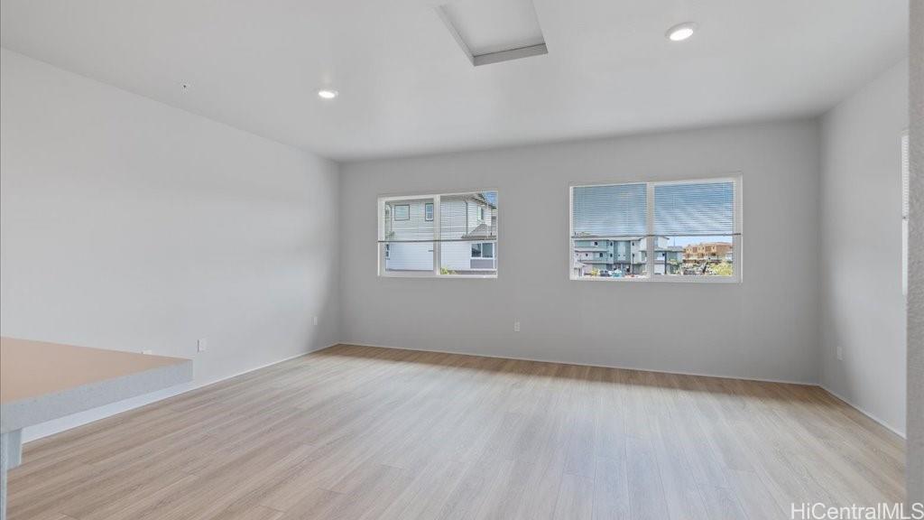 91-4099 Hikuono Street, Unit 1402 Kapolei, HI 96707 - Photo 7 of 25 an empty room with wooden floor and window