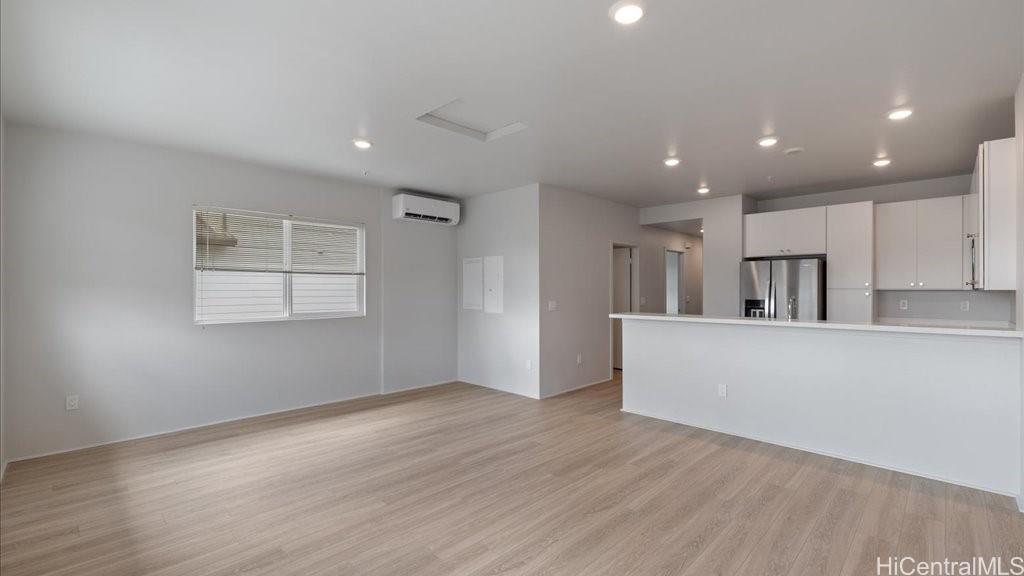 91-4099 Hikuono Street, Unit 1402 Kapolei, HI 96707 - Photo 8 of 25 a view of kitchen with wooden floor and window