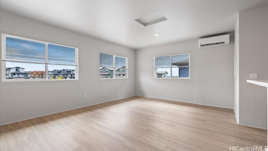 91-4099 Hikuono Street, Unit 1402 Kapolei, HI 96707 - Photo 10 of 25 a view of an empty room with a window and wooden floor