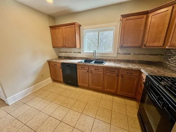 a kitchen with stainless steel appliances granite countertop a stove a sink dishwasher and a refrigerator