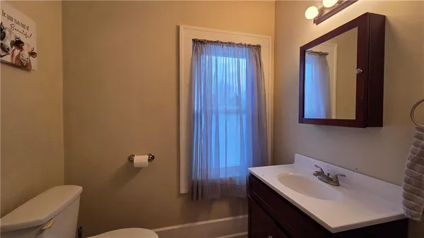 an empty room with a fan and a window