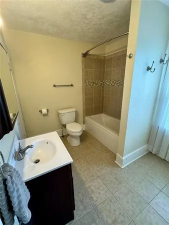 a bathroom with a tub sink and mirror