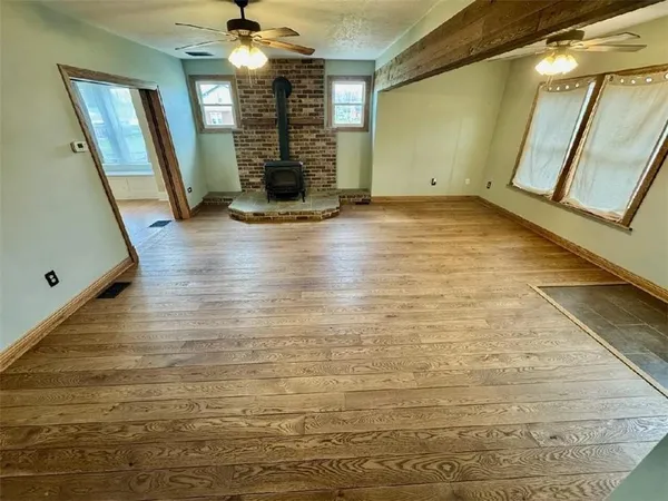 a view of a room with wooden floor