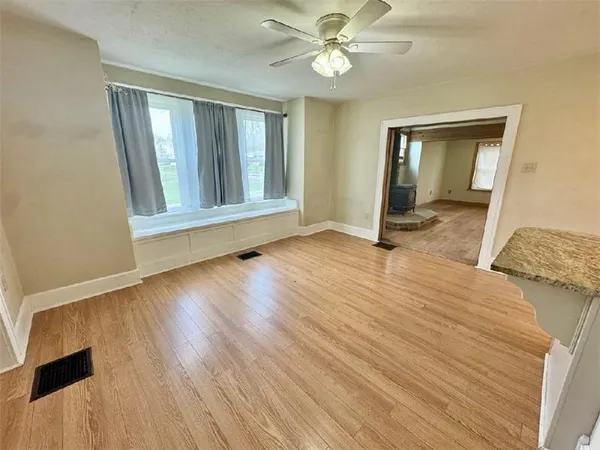 a large kitchen with a sink and dishwasher a stove top oven with wooden floor