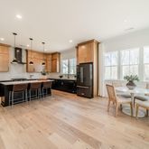 a kitchen with stainless steel appliances kitchen island granite countertop a sink and cabinets