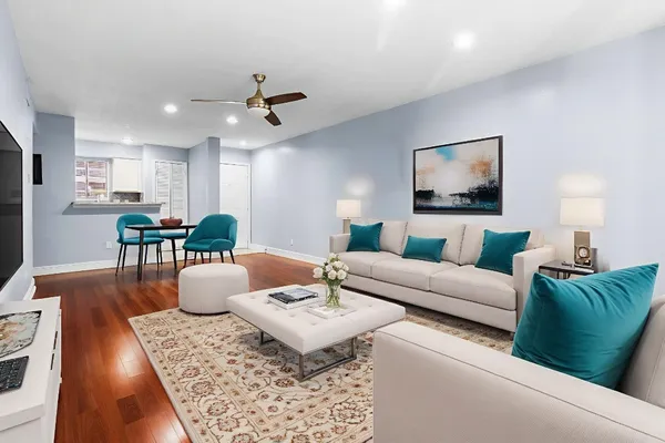 a living room with furniture and wooden floor