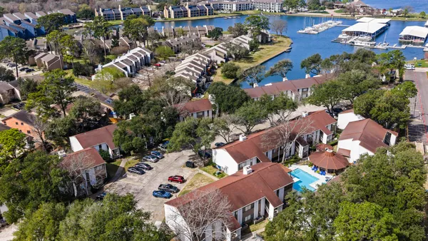 an aerial view of residential houses with outdoor space