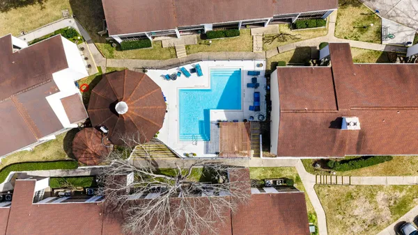an aerial view of residential house with outdoor space and parking