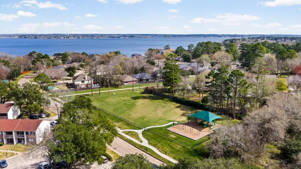 a view of a house with backyard and sitting area