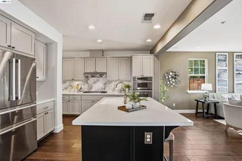 a kitchen with a sink stainless steel appliances and cabinets