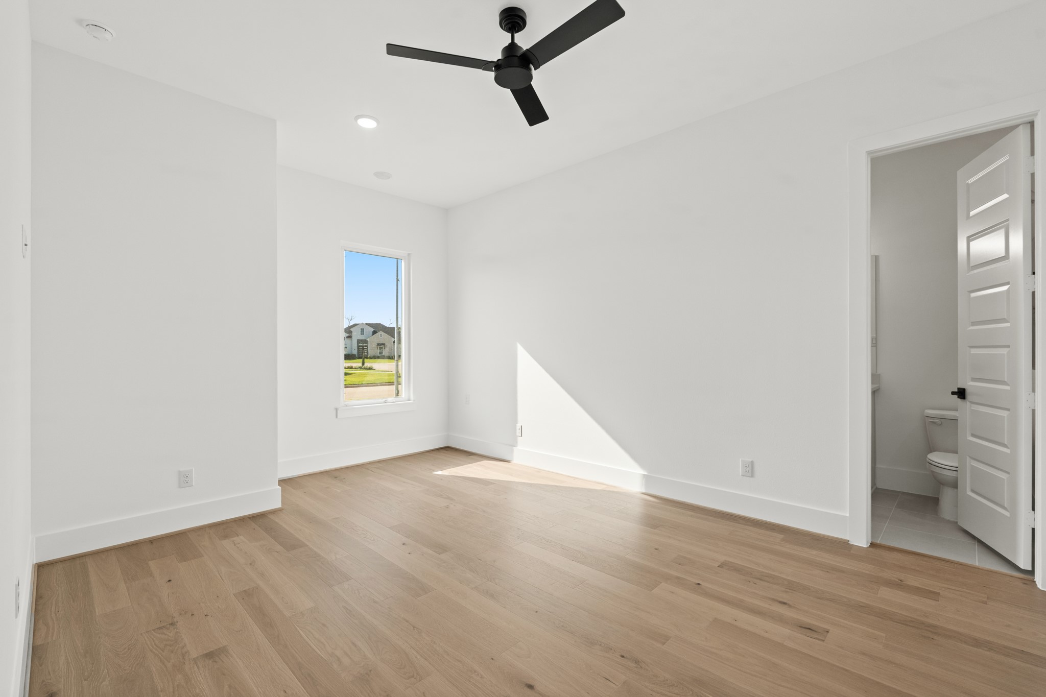 4210 Westgate Lane Fulshear, TX 77441 - Photo 11 of 48 wooden floor in an empty room with a window