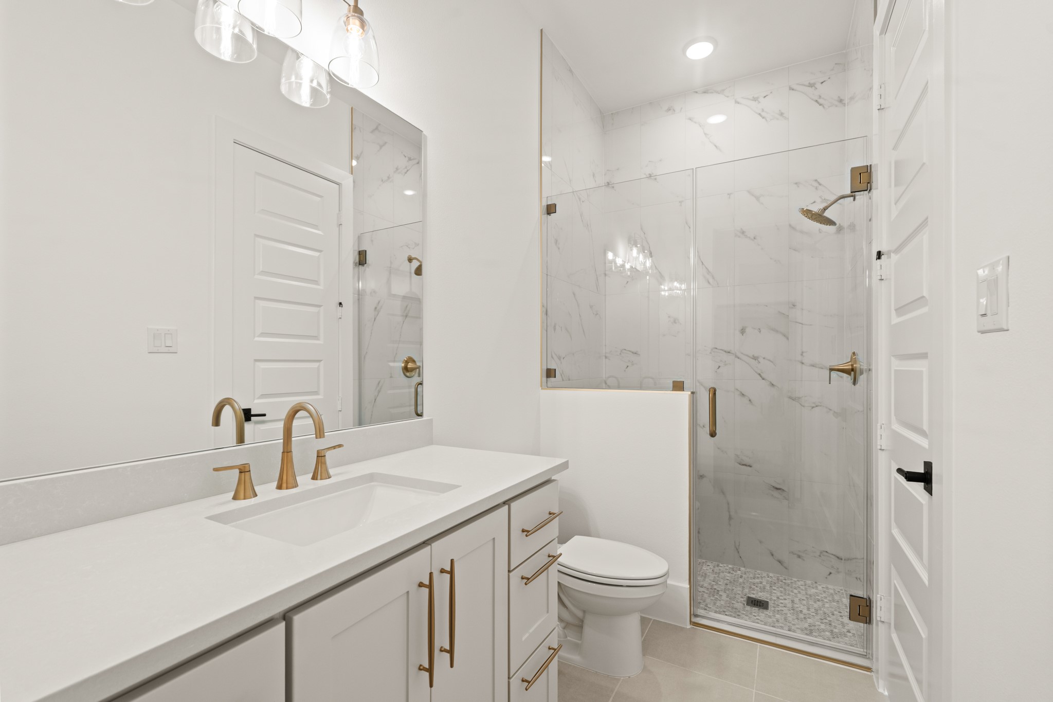 4210 Westgate Lane Fulshear, TX 77441 - Photo 13 of 48 a bathroom with a sink a toilet and shower