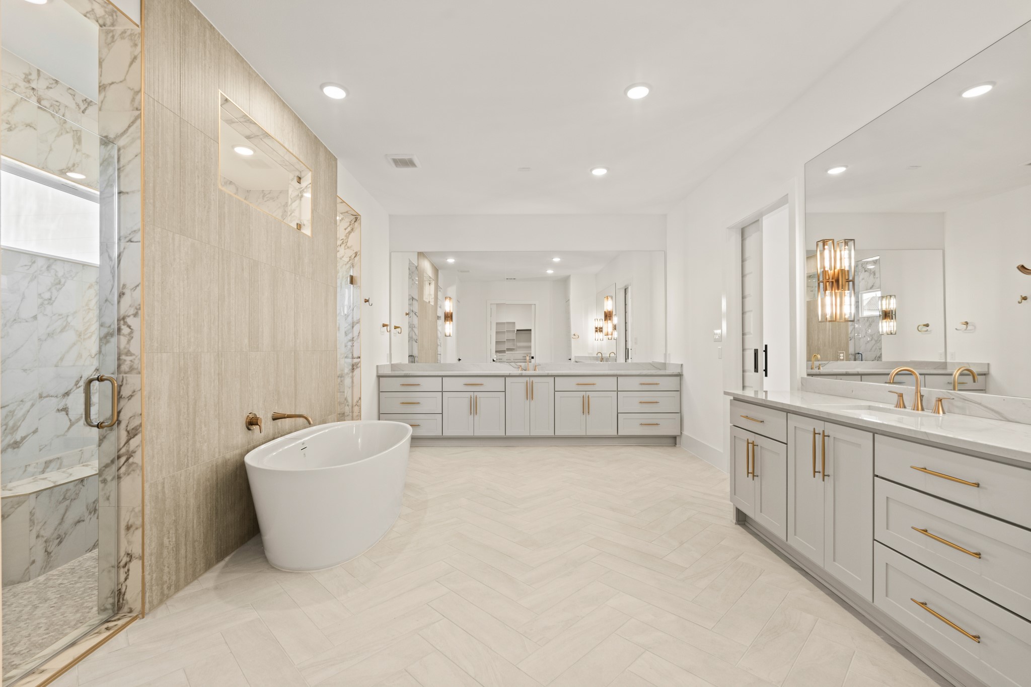 4210 Westgate Lane Fulshear, TX 77441 - Photo 18 of 48 a large bathroom with a tub a double vanity sink and mirror