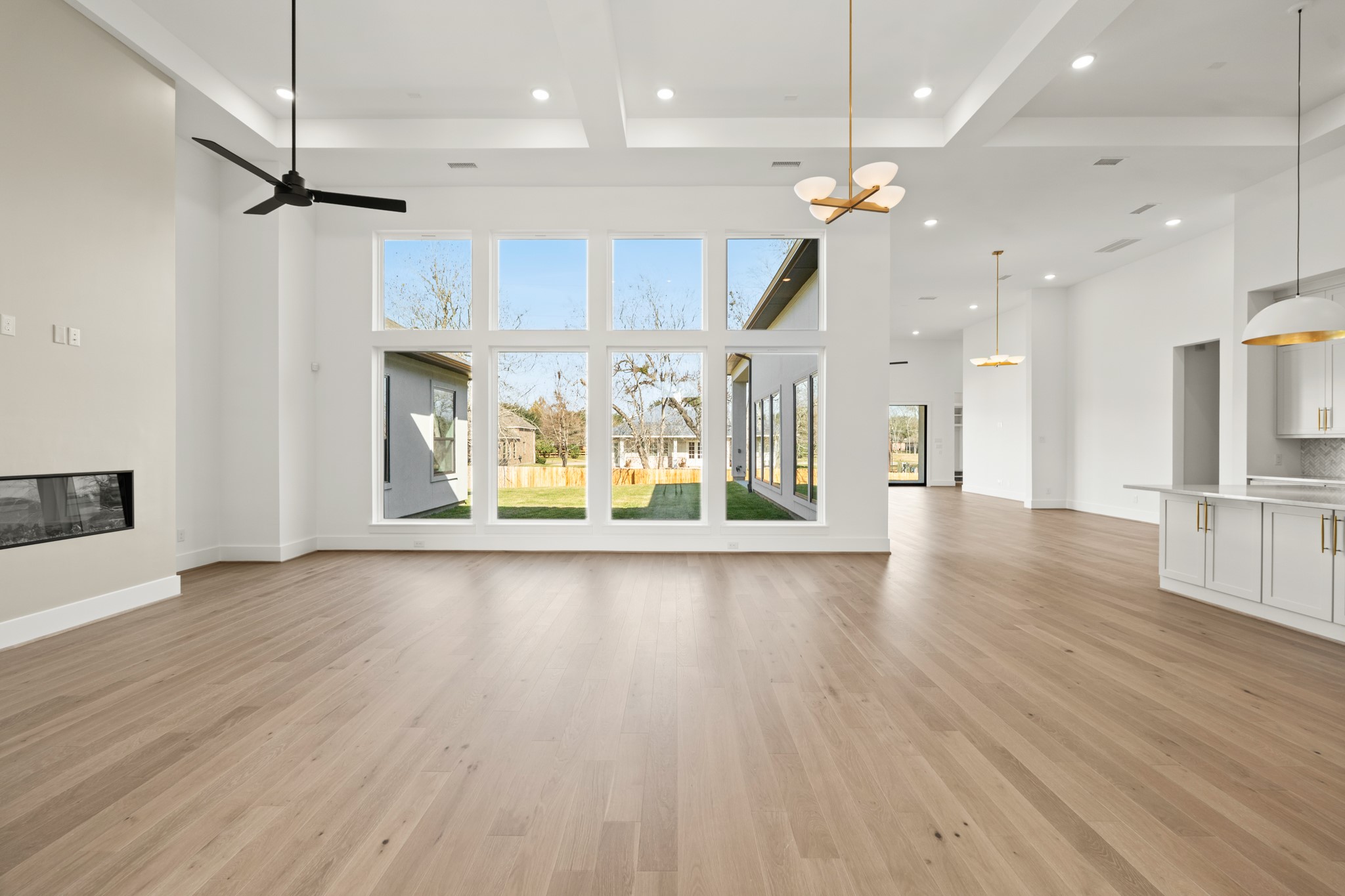 4210 Westgate Lane Fulshear, TX 77441 - Photo 23 of 48 wooden floor in an empty room with a kitchen