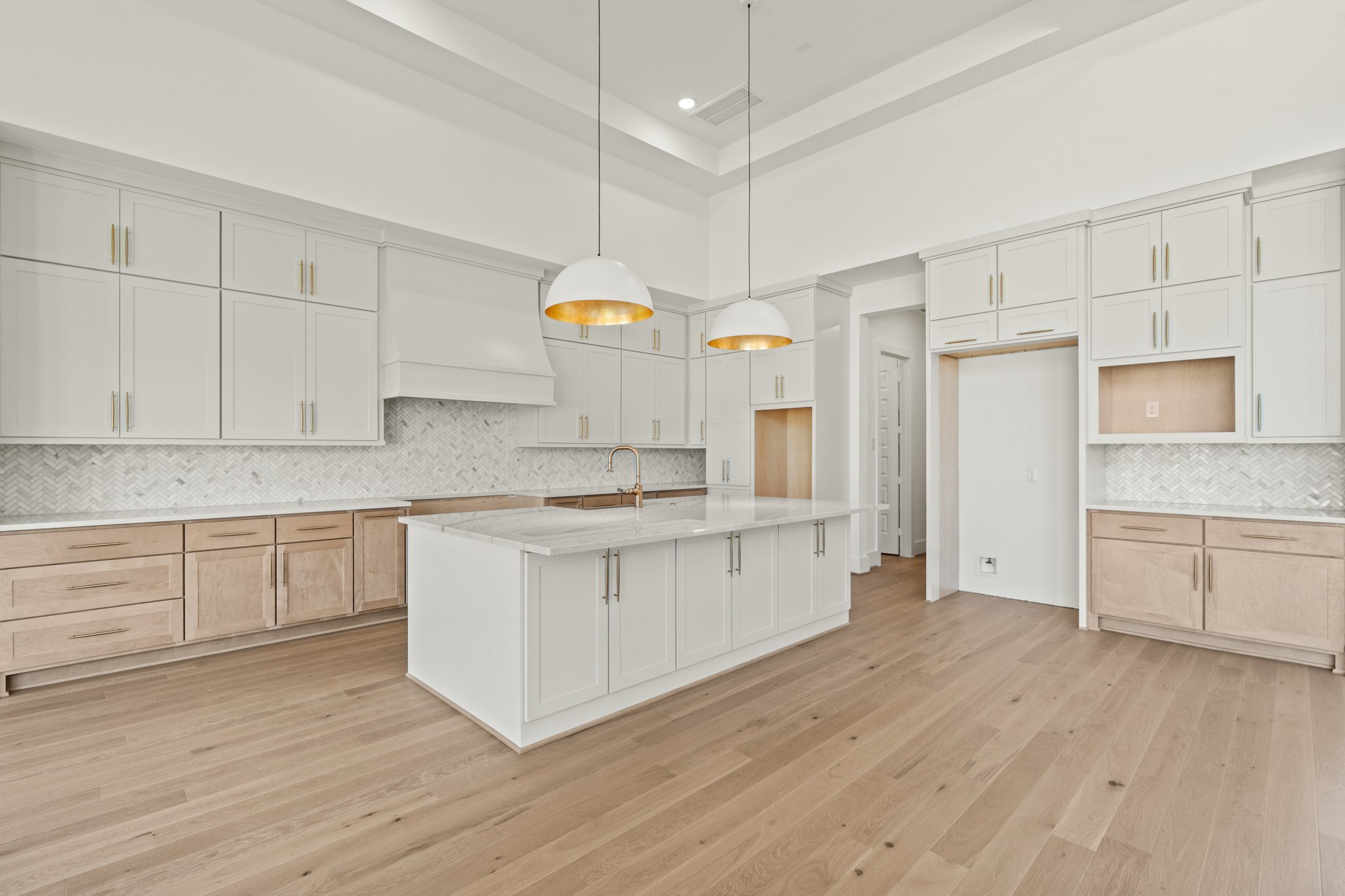 4210 Westgate Lane Fulshear, TX 77441 - Photo 28 of 48 a kitchen with granite countertop white cabinets and wooden floor