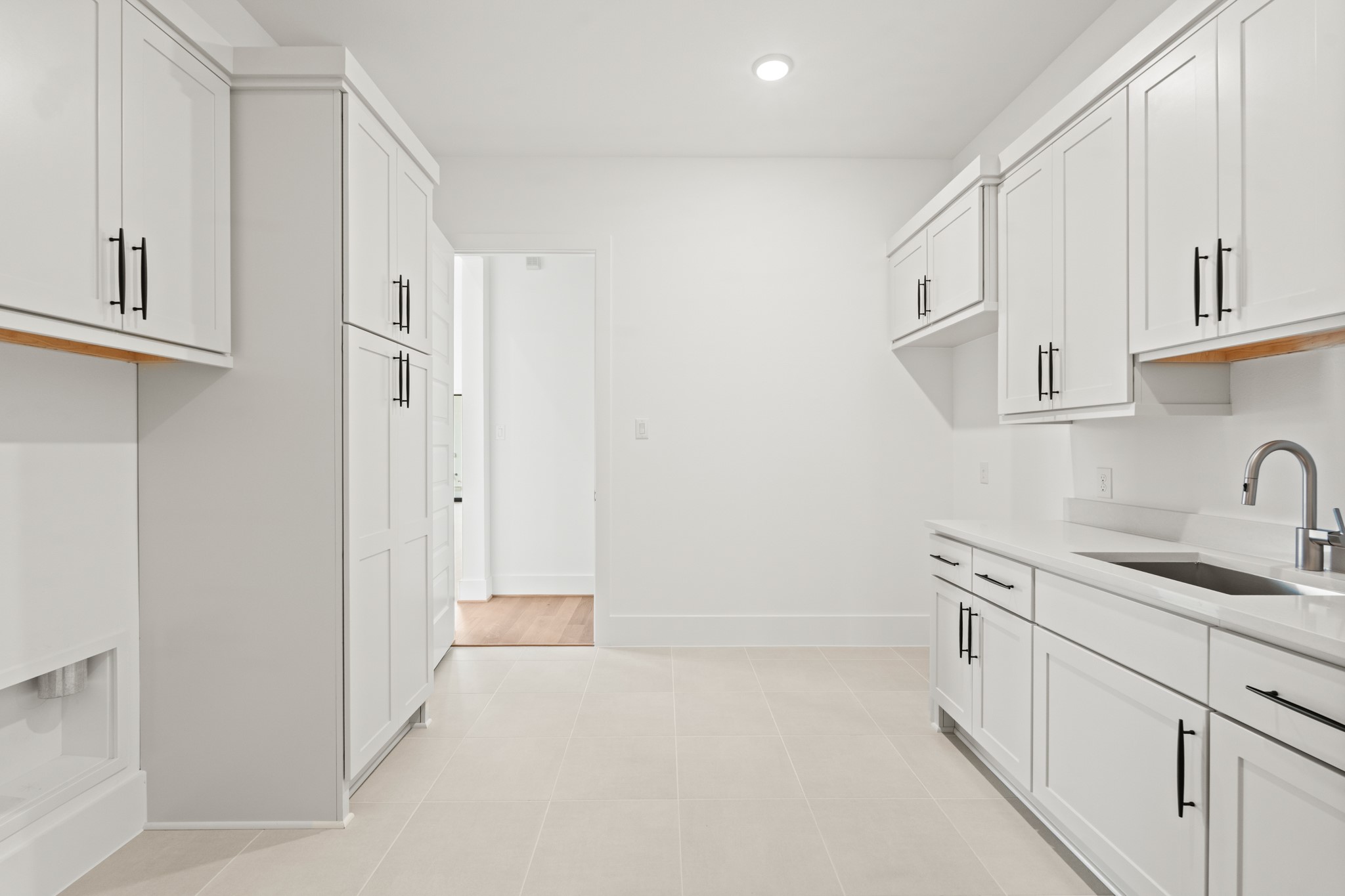 4210 Westgate Lane Fulshear, TX 77441 - Photo 40 of 48 a kitchen with white cabinets and sink