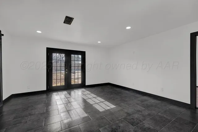 a view of an empty room with glass door