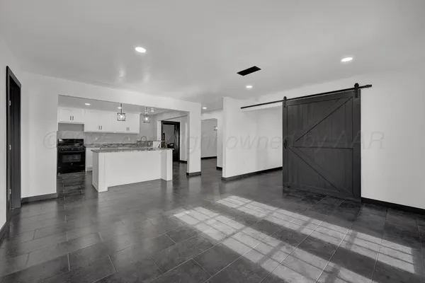 a view of a kitchen with a sink and a refrigerator
