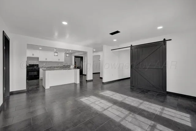 a view of a kitchen with a sink and a refrigerator