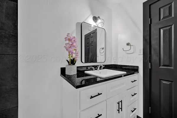 a bathroom with a sink and a mirror