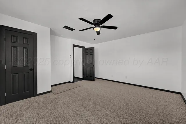 a view of a ceiling fan and a window