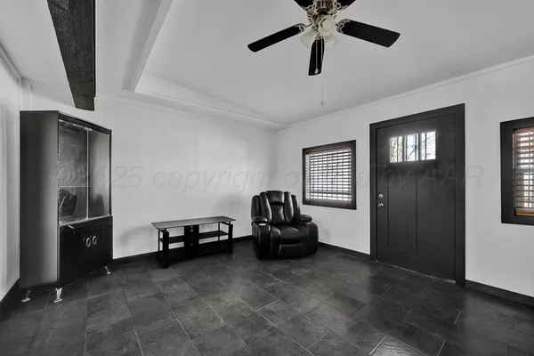 a living room with furniture and a ceiling fan