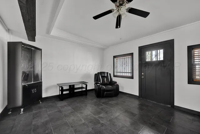 a living room with furniture and a ceiling fan