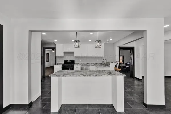 a large white kitchen with a large window