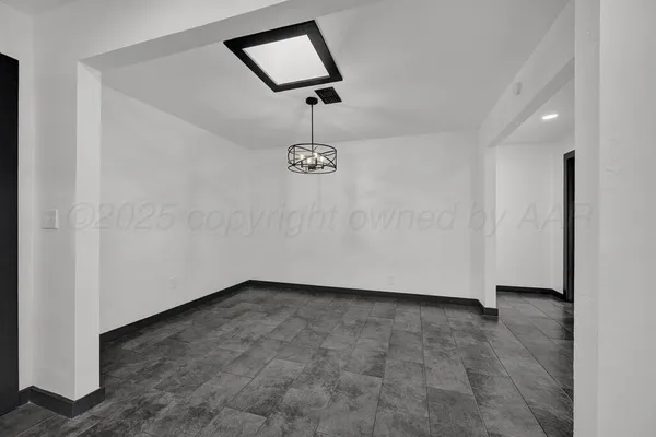 an empty room with a ceiling fan and carpet