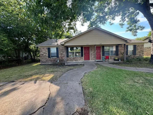 a front view of house with yard and green space