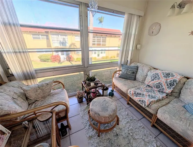 a living room with furniture and painting on the wall