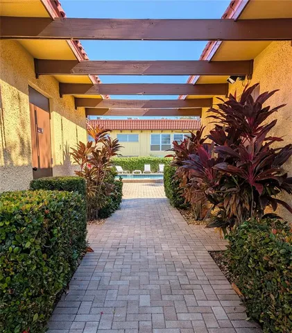 a front view of a house with swimming pool having outdoor seating