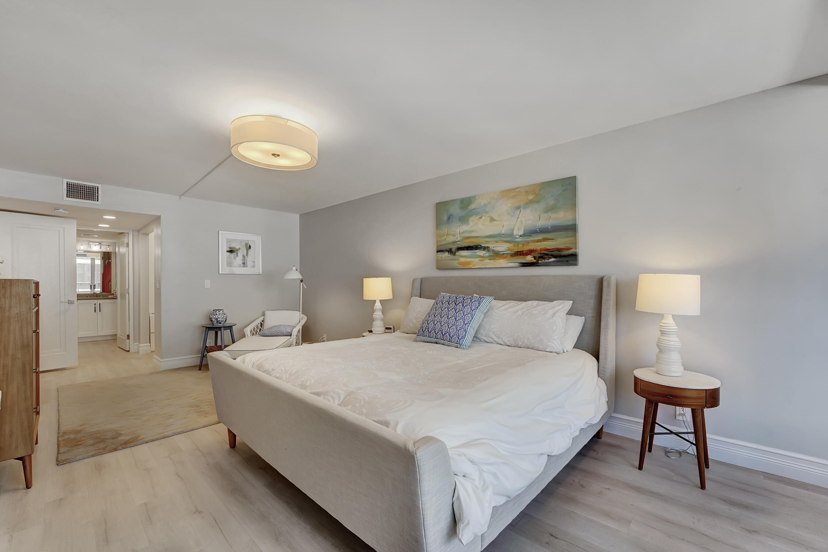 2175 South Ocean Boulevard, Unit 304 Delray Beach, FL 33483 - Photo 13 of 28 a spacious bedroom with a bed and a lamp