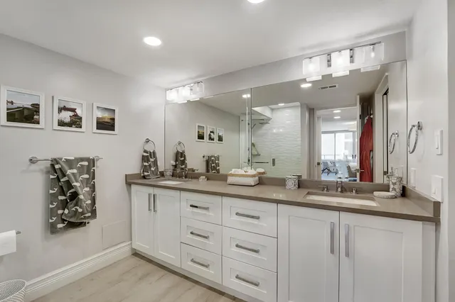 a bathroom with a sink vanity and mirror