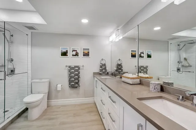 a spacious bathroom with a granite countertop sink mirror and toilet