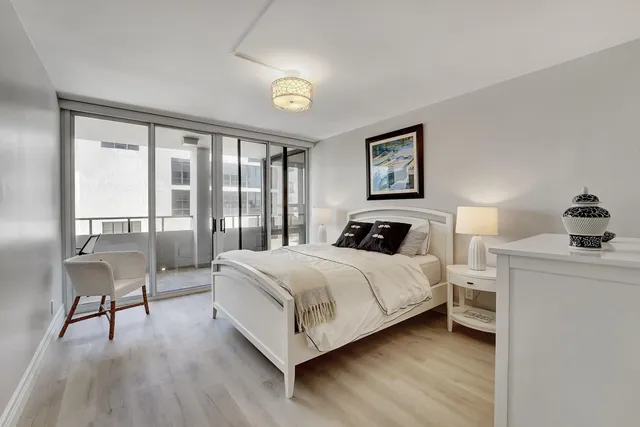 a bedroom with a bed and a large window