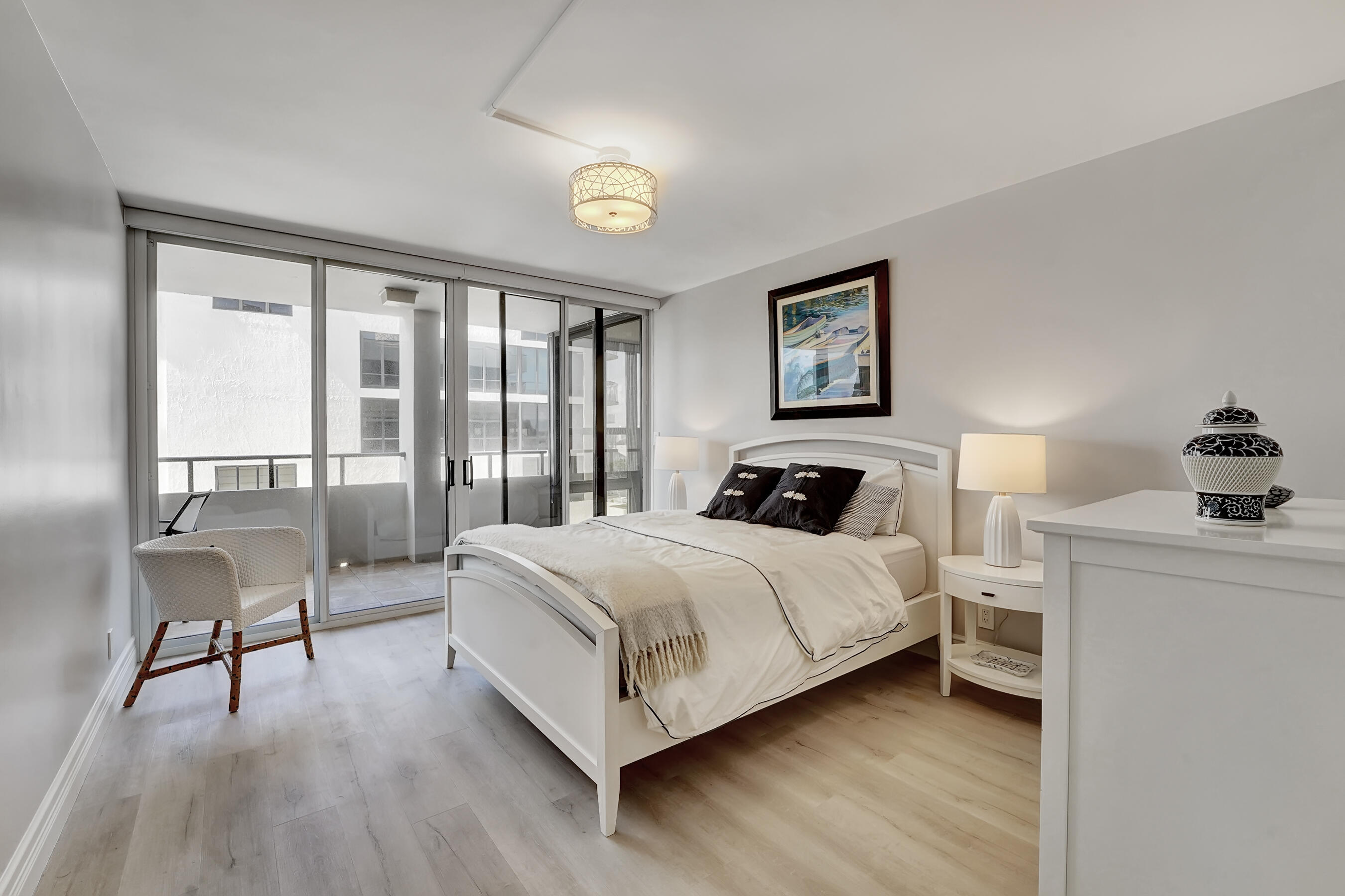 2175 South Ocean Boulevard, Unit 304 Delray Beach, FL 33483 - Photo 19 of 28 a bedroom with a bed and a large window