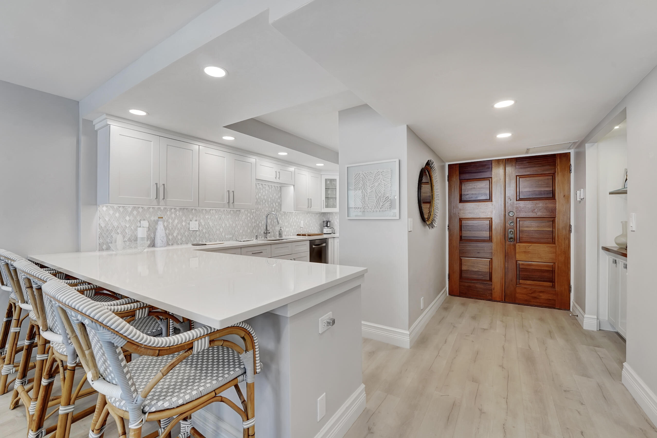 2175 South Ocean Boulevard, Unit 304 Delray Beach, FL 33483 - Photo 2 of 28 a view of kitchen with refrigerator cabinets and wooden floor