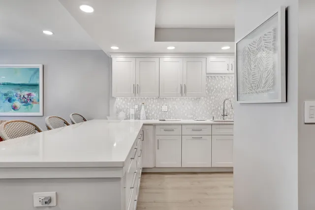 a kitchen with a sink cabinets and window