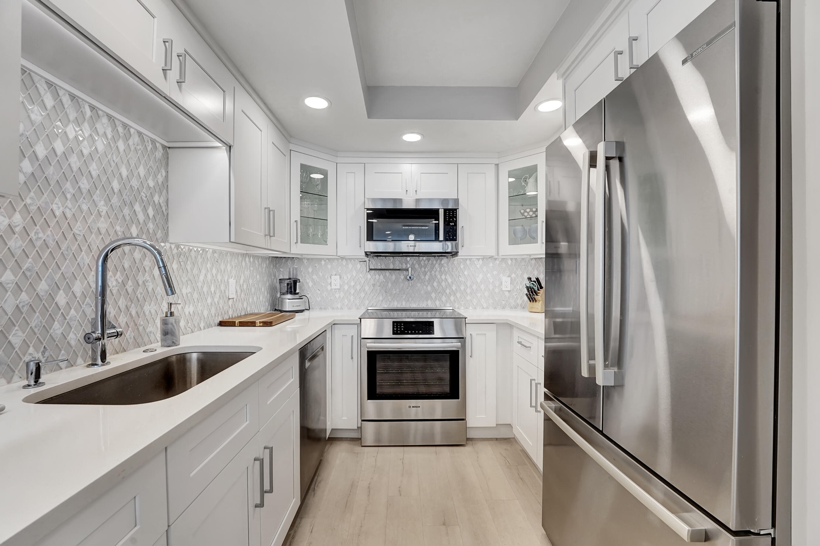 2175 South Ocean Boulevard, Unit 304 Delray Beach, FL 33483 - Photo 4 of 28 a kitchen with stainless steel appliances a refrigerator sink and microwave